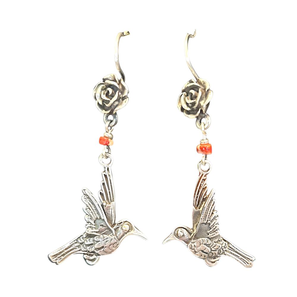 Handmade sterling earrings by a talented family of silversmiths in Peru. Silver bird and flower. Coral colored bead. We purchased these directly from this family. We love their work! 