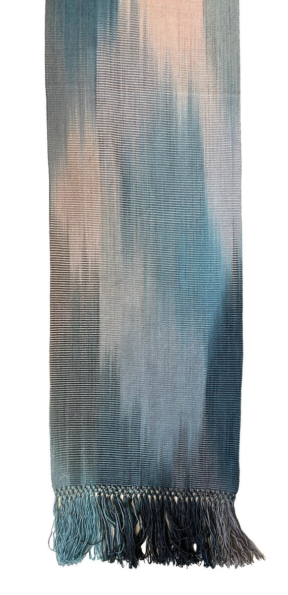 detail Handwoven bamboo scarf dyed and woven by hand by a women's cooperative. The colors are spaced dyed giving a beautiful effect of soft, flowing, changing colors. Light weight with a very soft feel. A cascade of color- pale blues, silver pink, and charcoal. 
